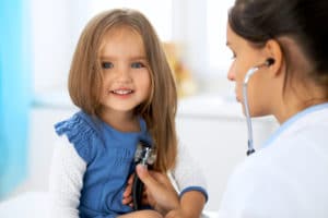 child patient get heart rate checked by doctor